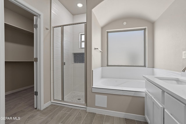 912 Malven Pl, El Paso, TX 79928 - bathroom featuring a stall shower, a spacious closet, a bath, and vanity