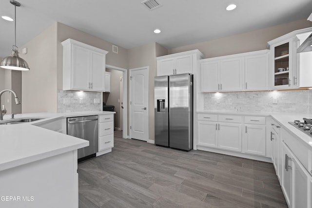 912 Malven Pl, El Paso, TX 79928 - kitchen with appliances with stainless steel finishes, white cabinetry, recessed lighting, tasteful backsplash, and decorative light fixtures