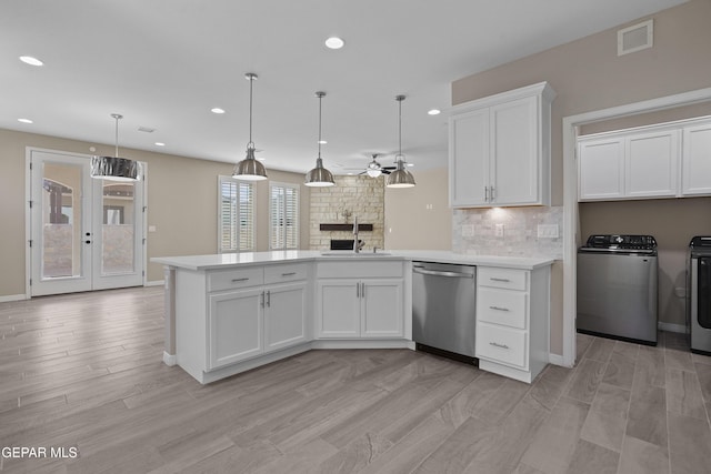 912 Malven Pl, El Paso, TX 79928 - kitchen with stainless steel dishwasher, a peninsula, recessed lighting, light countertops, and light wood-type flooring