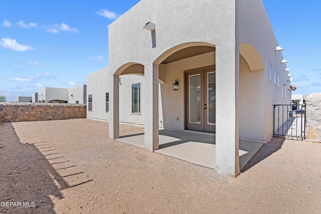 912 Malven Pl, El Paso, TX 79928 - rear view of house with stucco siding, a patio, a gate, and french doors