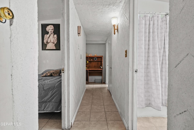 5828 Blackhawk Dr, El Paso, TX 79924 - corridor with tile patterned flooring, a textured ceiling, and a textured wall