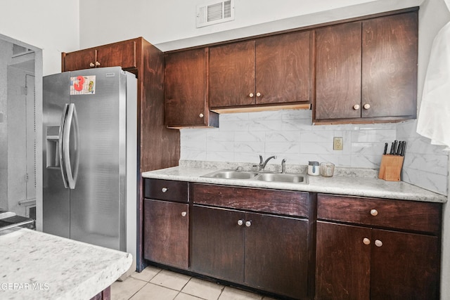 5828 Blackhawk Dr, El Paso, TX 79924 - kitchen featuring stainless steel fridge with ice dispenser, light countertops, decorative backsplash, and light tile patterned floors