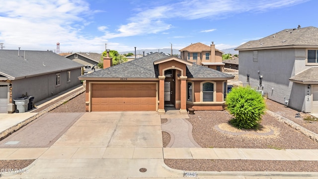 4609 Al Hernandez St, El Paso, TX 79938 - view of front of home featuring an attached garage, concrete driveway, a shingled roof, and a residential view