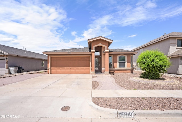 4609 Al Hernandez St, El Paso, TX 79938 - view of front of home featuring an attached garage, concrete driveway, and stucco siding