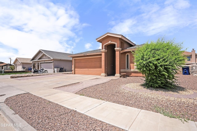 4609 Al Hernandez St, El Paso, TX 79938 - view of front of home with concrete driveway, an attached garage, and stucco siding