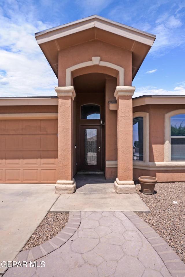 4609 Al Hernandez St, El Paso, TX 79938 - entrance to property with concrete driveway, a garage, and stucco siding