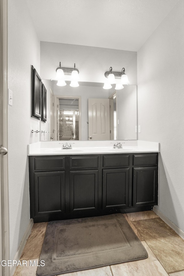 4609 Al Hernandez St, El Paso, TX 79938 - bathroom featuring double vanity and baseboards