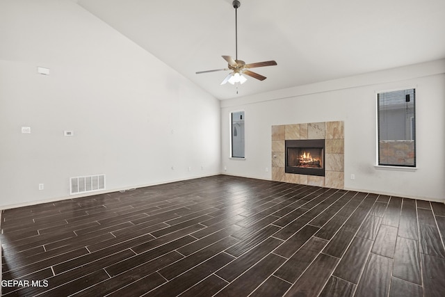 4609 Al Hernandez St, El Paso, TX 79938 - unfurnished living room with wood finished floors, ceiling fan, a tiled fireplace, and high vaulted ceiling
