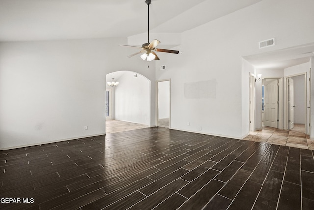 4609 Al Hernandez St, El Paso, TX 79938 - unfurnished living room with wood finished floors, high vaulted ceiling, arched walkways, a ceiling fan, and a chandelier