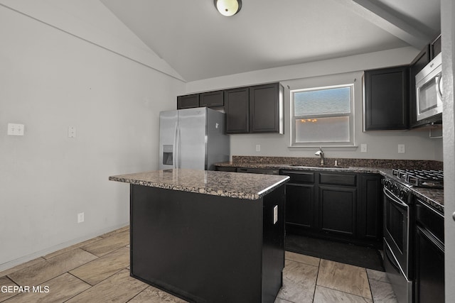 4609 Al Hernandez St, El Paso, TX 79938 - kitchen with stainless steel appliances, a center island, lofted ceiling, dark cabinetry, and dark stone counters
