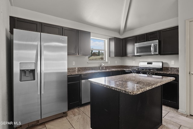 4609 Al Hernandez St, El Paso, TX 79938 - kitchen with stainless steel appliances, dark stone counters, a center island, and dark cabinets