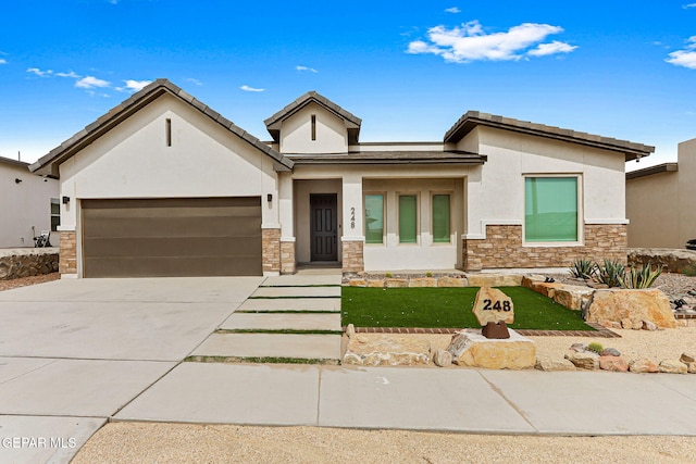 248 Farnborough St, El Paso, TX 79928 - view of front of property featuring stucco siding, stone siding, a garage, driveway, and a front lawn