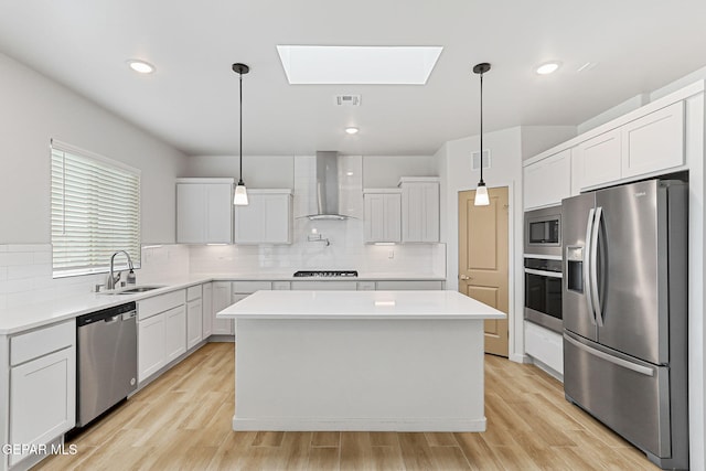 248 Farnborough St, El Paso, TX 79928 - kitchen featuring appliances with stainless steel finishes, wall chimney range hood, a skylight, light countertops, and recessed lighting