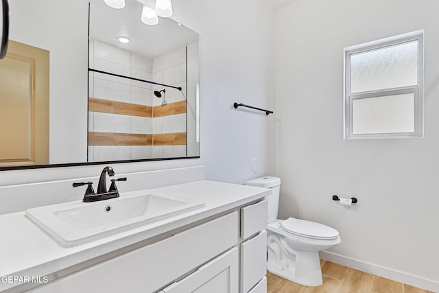 248 Farnborough St, El Paso, TX 79928 - bathroom featuring wood finished floors, vanity, and tiled shower