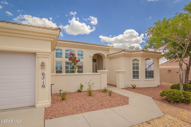 6316 Franklin Red Dr, El Paso, TX 79912 - mediterranean / spanish-style home with stucco siding, a garage, and a tiled roof