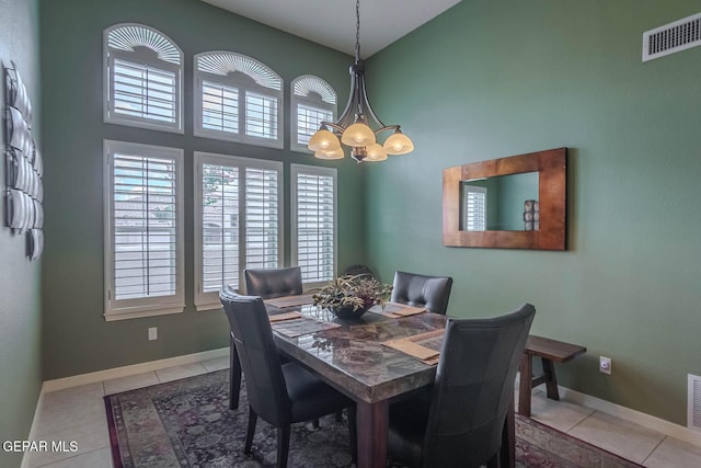 6316 Franklin Red Dr, El Paso, TX 79912 - dining area with a towering ceiling, plenty of natural light, a chandelier, and tile patterned flooring
