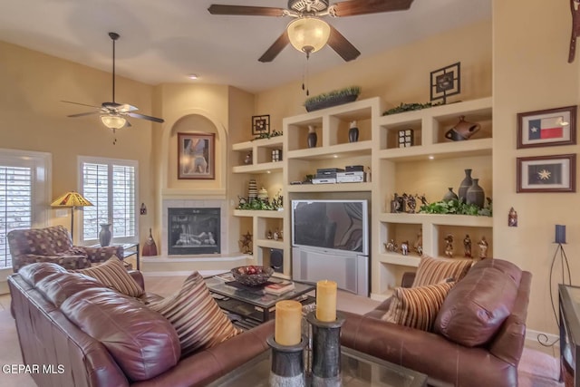 6316 Franklin Red Dr, El Paso, TX 79912 - living area featuring ceiling fan, built in shelves, and a glass covered fireplace