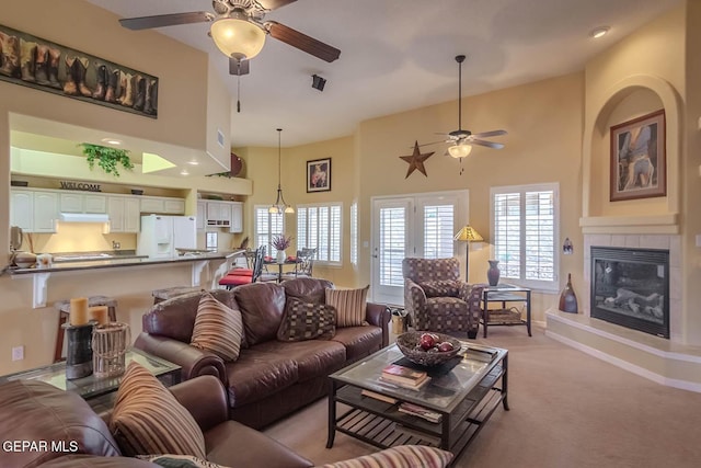 6316 Franklin Red Dr, El Paso, TX 79912 - living area with a ceiling fan, a high ceiling, light carpet, and a fireplace