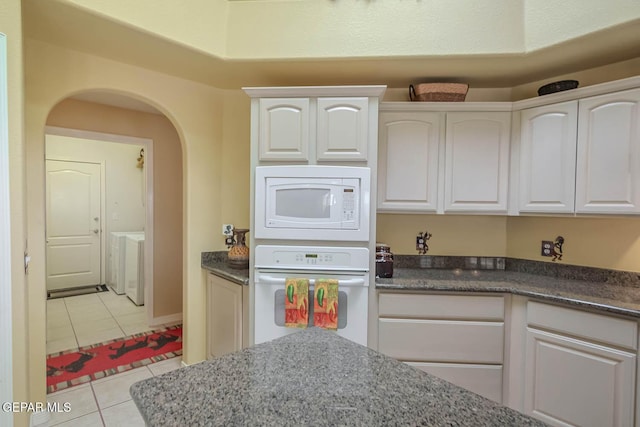 6316 Franklin Red Dr, El Paso, TX 79912 - kitchen with white appliances, arched walkways, light tile patterned flooring, and white cabinetry
