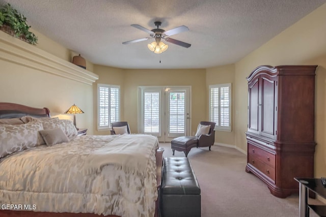 6316 Franklin Red Dr, El Paso, TX 79912 - bedroom featuring light colored carpet, access to exterior, a textured ceiling, and a ceiling fan