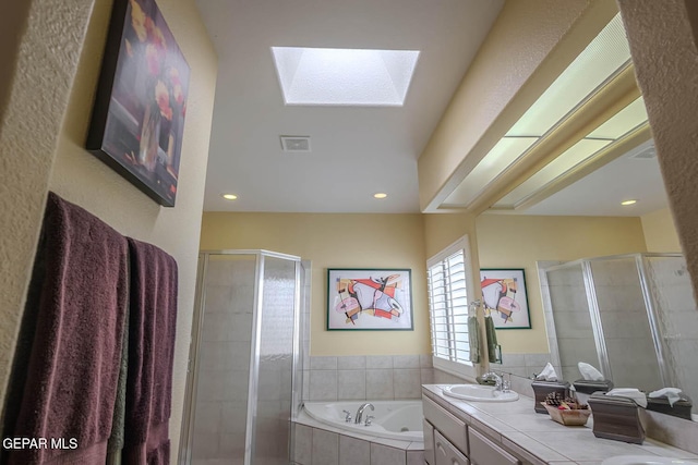 6316 Franklin Red Dr, El Paso, TX 79912 - full bathroom featuring a skylight, a stall shower, double vanity, a whirlpool tub, and recessed lighting