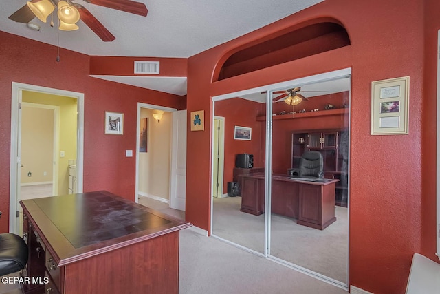 6316 Franklin Red Dr, El Paso, TX 79912 - office area with ceiling fan, light carpet, and a textured wall