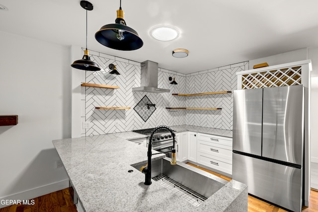 721 Mesita Dr, El Paso, TX 79902 - kitchen featuring freestanding refrigerator, open shelves, backsplash, and wall chimney exhaust hood