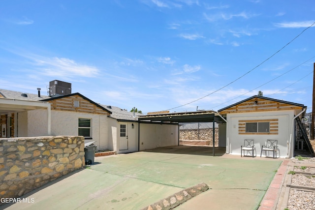 721 Mesita Dr, El Paso, TX 79902 - rear view of property featuring stucco siding and concrete driveway