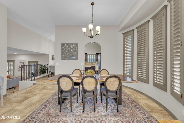 7817 Enchanted Trail Dr, El Paso, TX 79911 - dining space with arched walkways, a chandelier, and light stone finish flooring