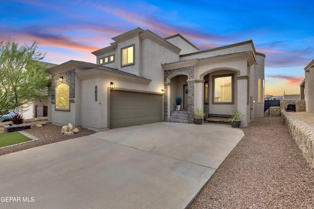 7817 Enchanted Trail Dr, El Paso, TX 79911 - view of front of house featuring driveway, stucco siding, a garage, and stone siding