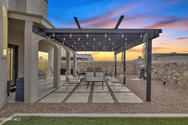 7817 Enchanted Trail Dr, El Paso, TX 79911 - patio terrace at dusk featuring a patio, outdoor dining space, a pergola, and a grill