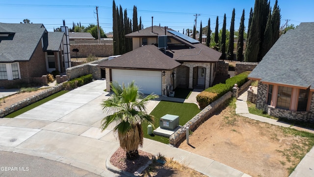 11713 Queens Garden Cir, El Paso, TX 79936 - view of front facade with driveway, a garage, brick siding, and a shingled roof