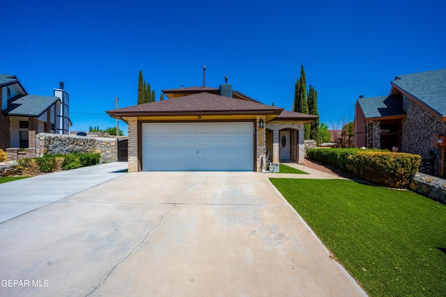 11713 Queens Garden Cir, El Paso, TX 79936 - view of front of home featuring driveway, a garage, a front yard, and brick siding