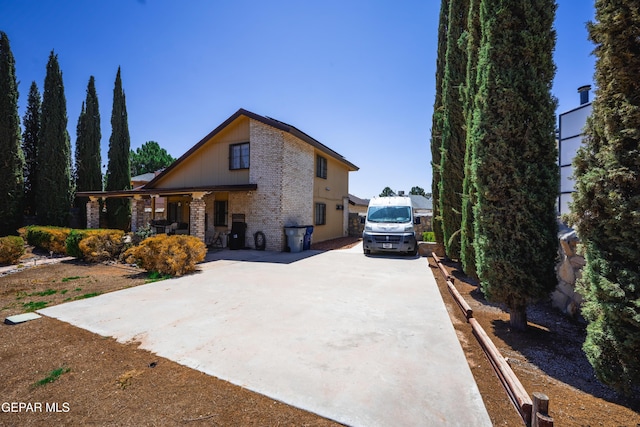 11713 Queens Garden Cir, El Paso, TX 79936 - view of front of house featuring brick siding, a porch, and driveway