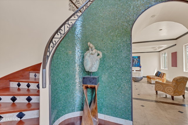 4540 N Stanton St, El Paso, TX 79902 - stairs with tile patterned flooring, tile walls, ornamental molding, and inlaid floor details