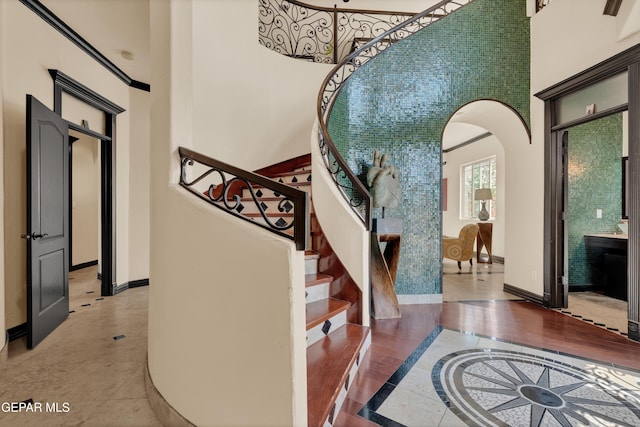 4540 N Stanton St, El Paso, TX 79902 - entrance foyer featuring a towering ceiling, arched walkways, inlaid floor details, and stairway