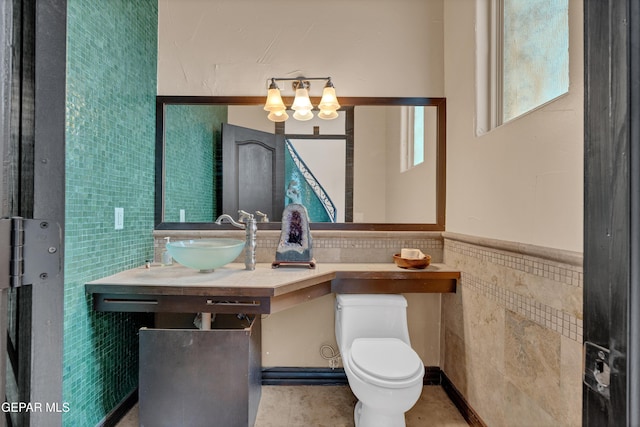 4540 N Stanton St, El Paso, TX 79902 - bathroom with tile walls, a chandelier, vanity, and wainscoting