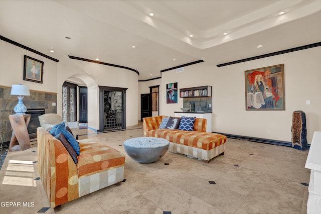 4540 N Stanton St, El Paso, TX 79902 - living room with recessed lighting, a glass covered fireplace, arched walkways, and ornamental molding