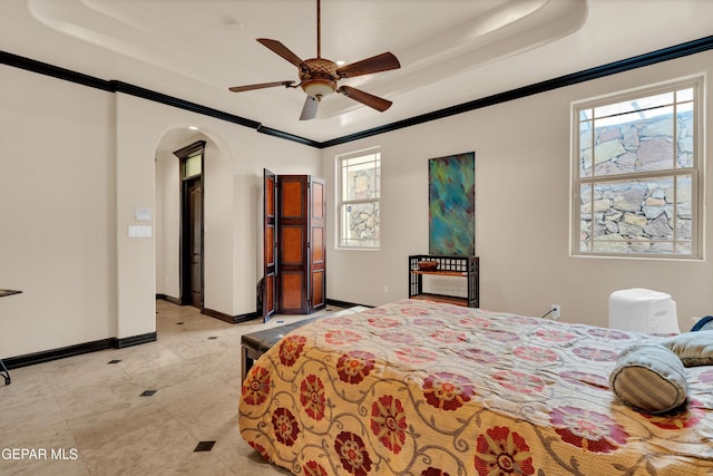4540 N Stanton St, El Paso, TX 79902 - bedroom with arched walkways, crown molding, multiple windows, a tray ceiling, and a ceiling fan