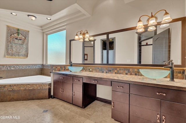 4540 N Stanton St, El Paso, TX 79902 - bathroom with double vanity, a chandelier, a garden tub, a shower stall, and tile patterned flooring