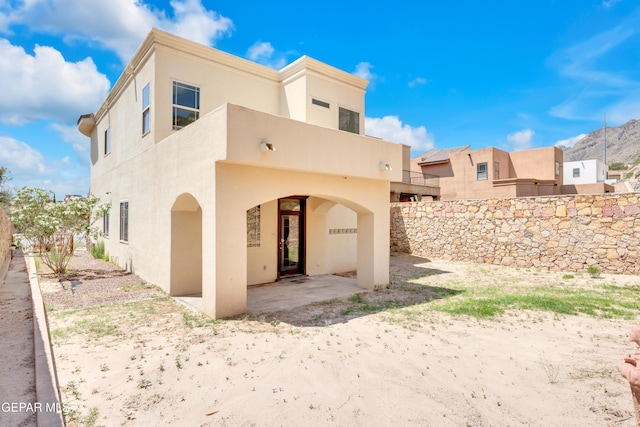 4540 N Stanton St, El Paso, TX 79902 - rear view of house featuring stucco siding and a patio area