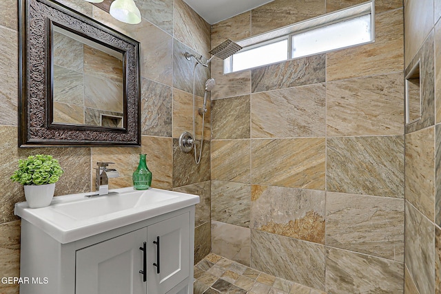 10304 Thor St, El Paso, TX 79924 - bathroom featuring tile walls, a tile shower, and vanity