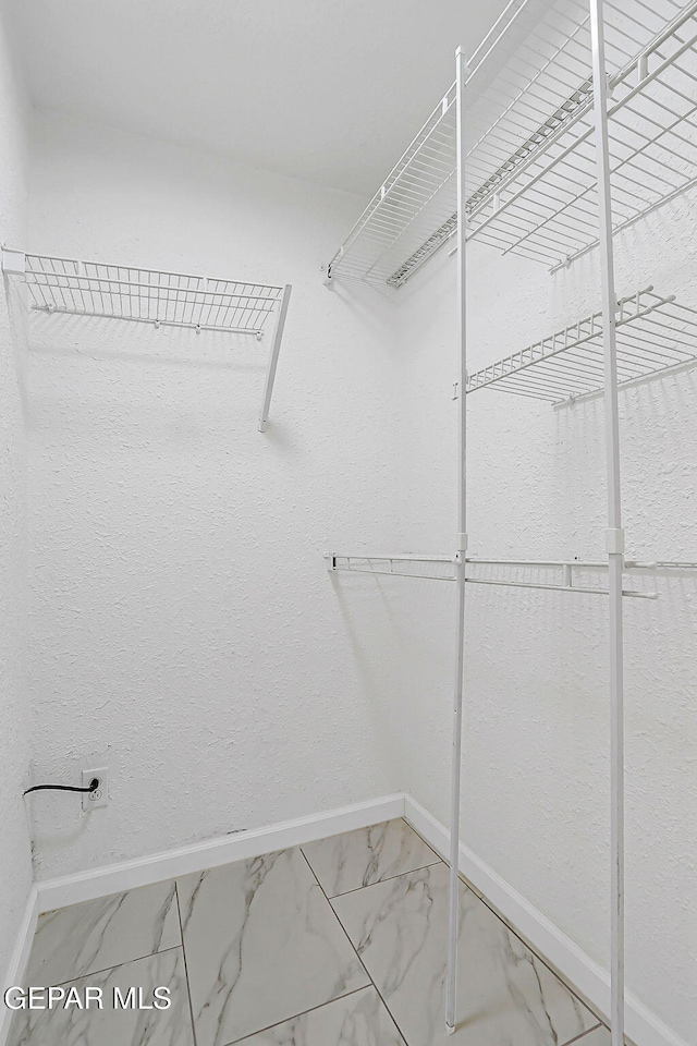 10304 Thor St, El Paso, TX 79924 - spacious closet featuring marble look tiles