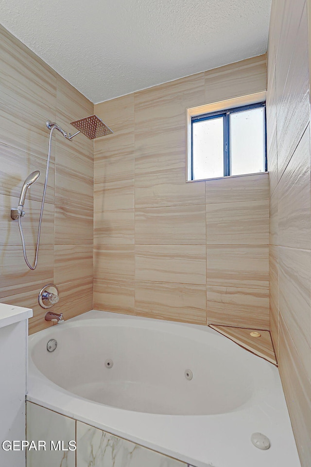 10304 Thor St, El Paso, TX 79924 - full bathroom featuring a textured ceiling and a combined bath / shower with jetted tub