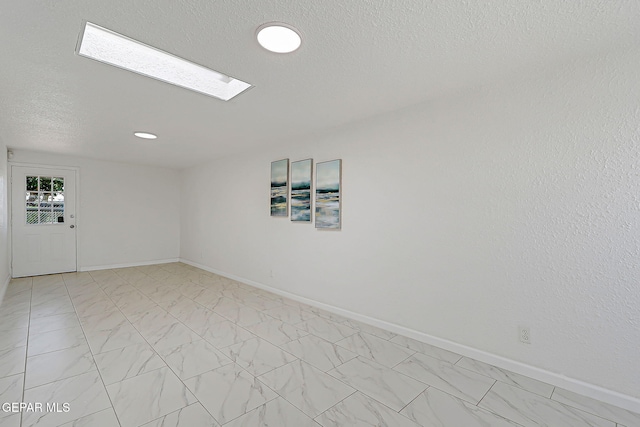 10304 Thor St, El Paso, TX 79924 - spare room with light marble finish flooring and a textured ceiling