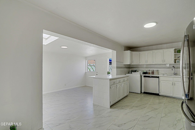 10304 Thor St, El Paso, TX 79924 - kitchen with appliances with stainless steel finishes, washer / clothes dryer, light countertops, and white cabinetry