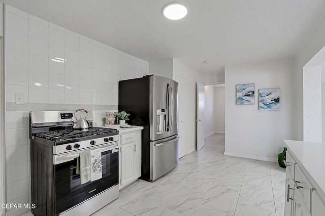 10304 Thor St, El Paso, TX 79924 - kitchen with appliances with stainless steel finishes, light countertops, light marble finish floors, and white cabinets