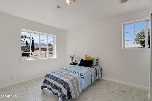 10304 Thor St, El Paso, TX 79924 - bedroom featuring multiple windows and marble look tiles
