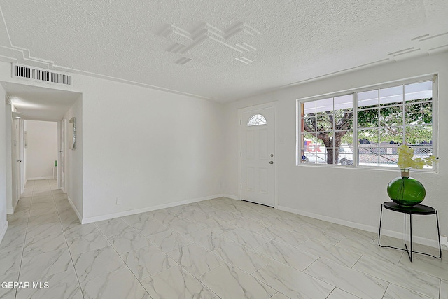 10304 Thor St, El Paso, TX 79924 - foyer entrance featuring a textured ceiling and light marble finish floors