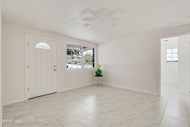 10304 Thor St, El Paso, TX 79924 - entrance foyer featuring a textured ceiling, healthy amount of natural light, and light marble finish flooring